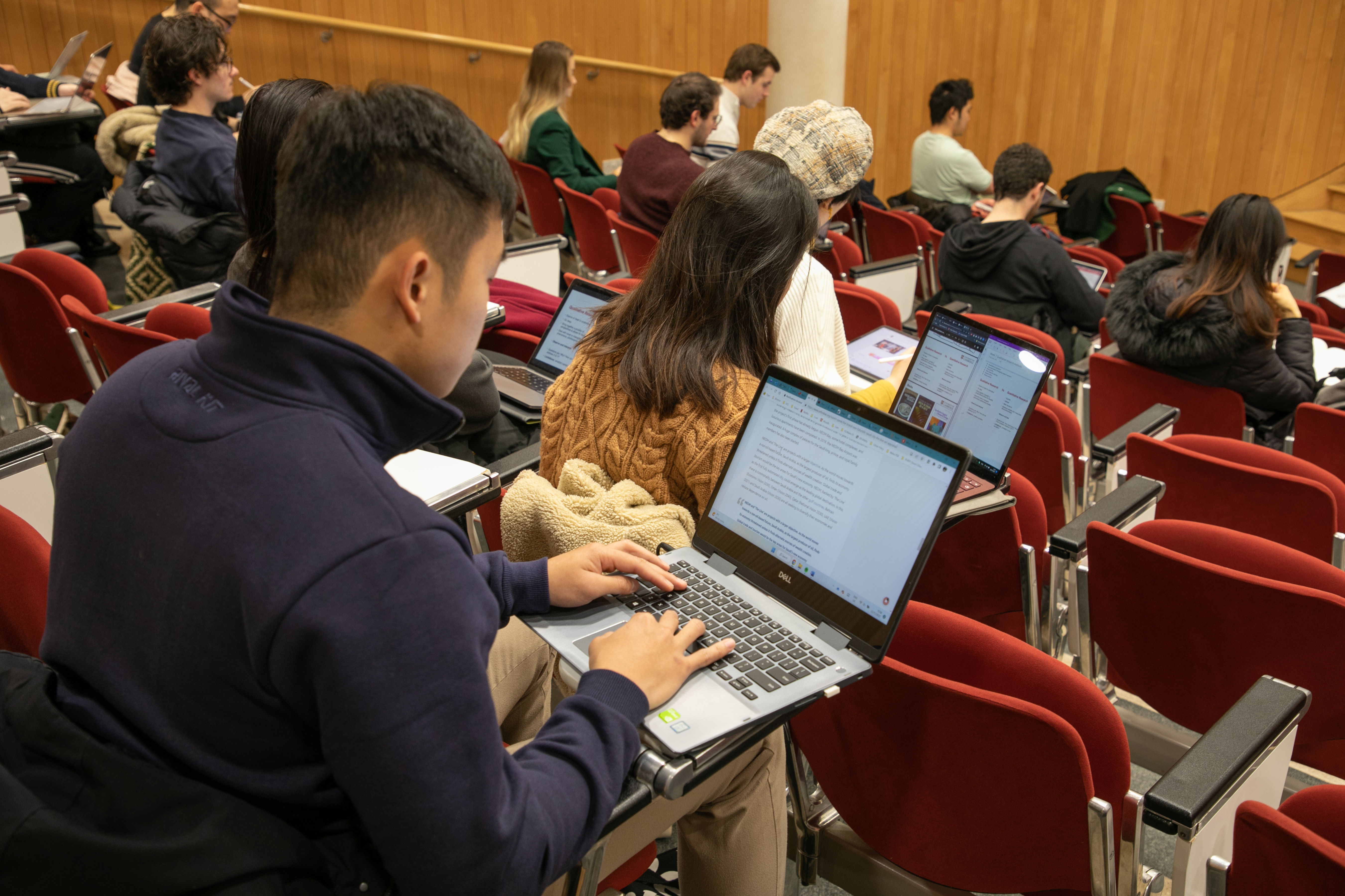 students in a lecture hall taking notes