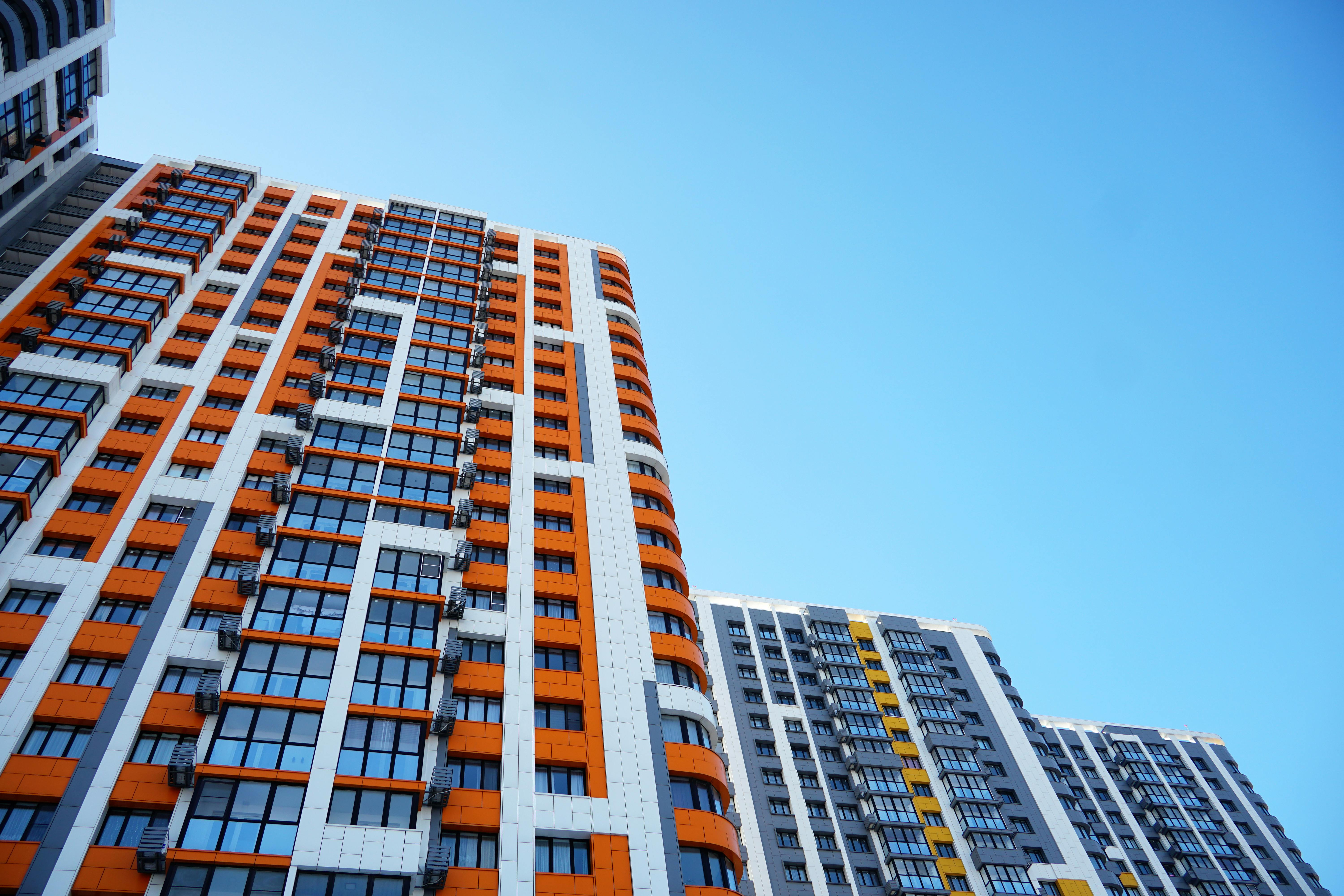 Modern high-rise urban architecture with white and orange cladding