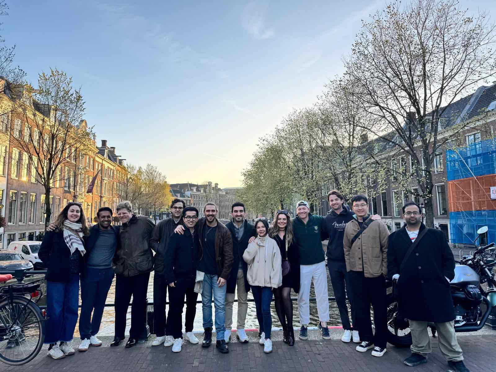 A photograph of a group of MSt in Real Estate students standing on a bridge in Amsterdam in wintery weather.