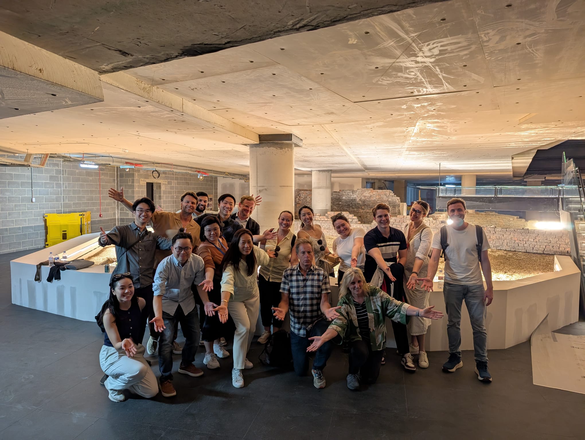A photograph of MSt in Real Estate students in an underground concrete space, posing theatrically.